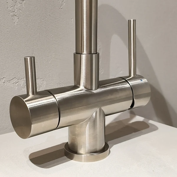 Close view of faucet controls against a neutral background.