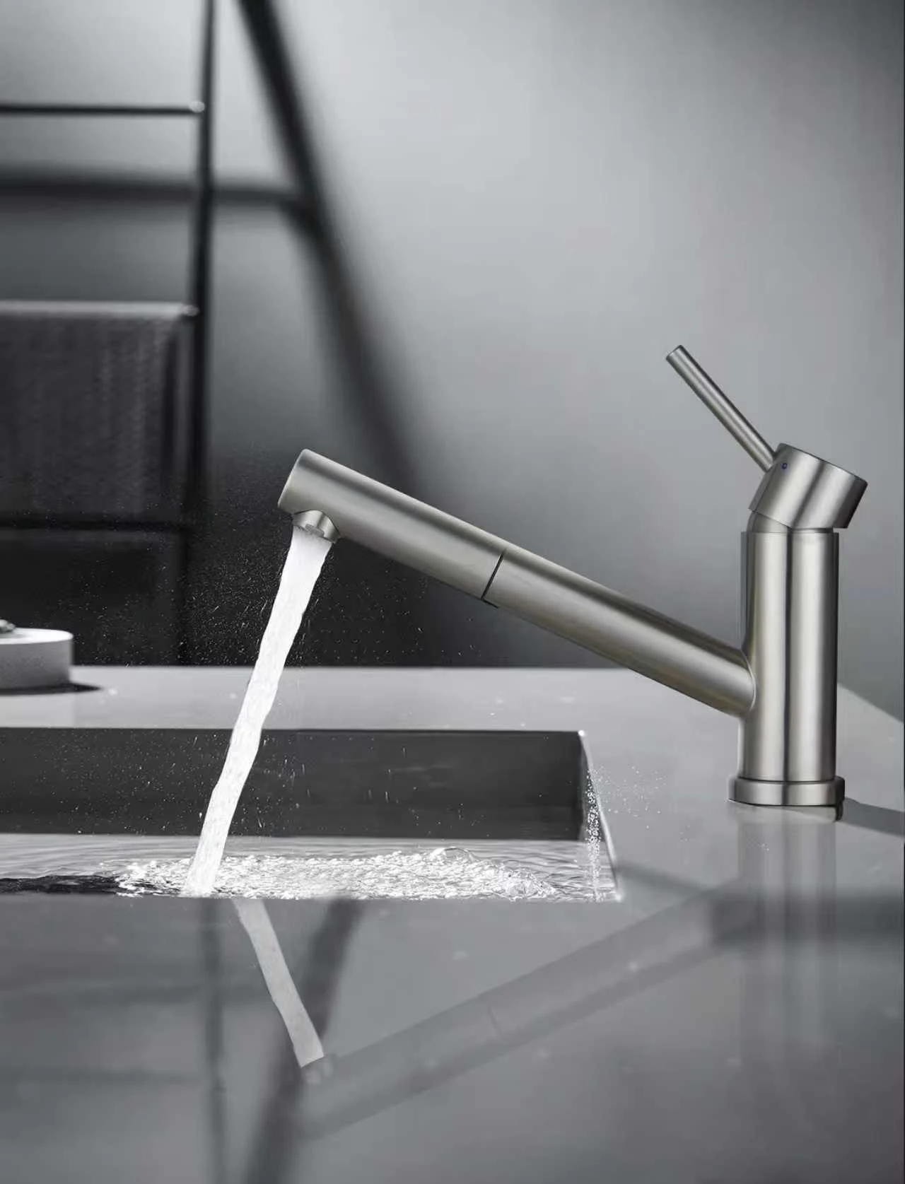 Angled-spout faucet running into a bathroom basin.