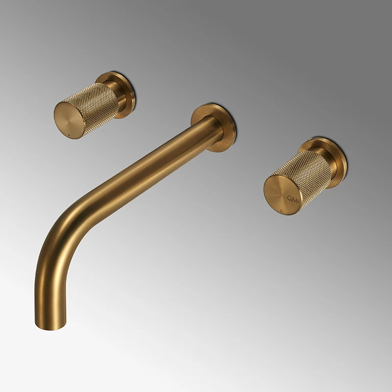 Gold-tone wall-mounted faucet and separate controls.