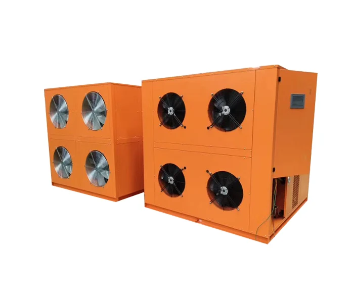 Two orange industrial heat-pump units with ventilation fans.