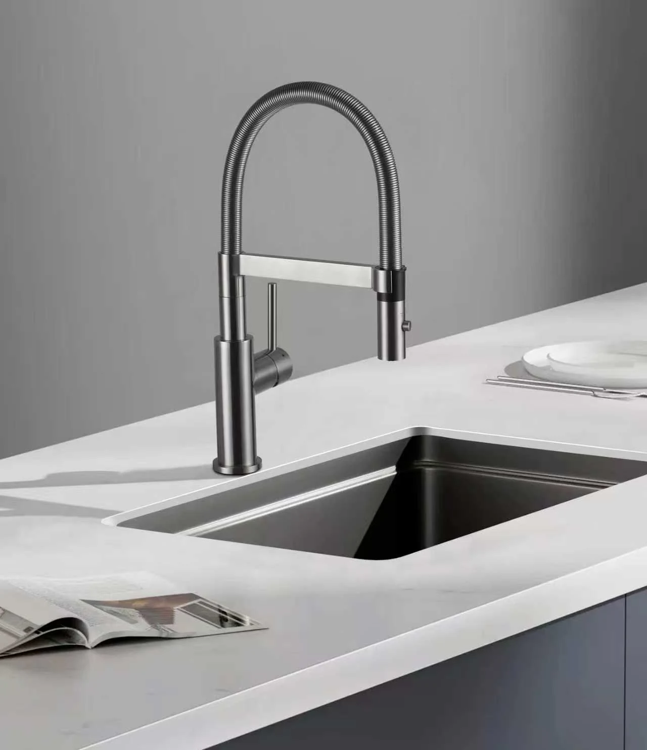 Spring-spout kitchen faucet above a stainless steel sink.