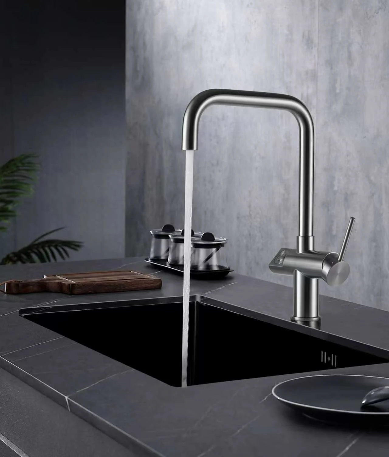 Square-spout kitchen faucet running over a sink.