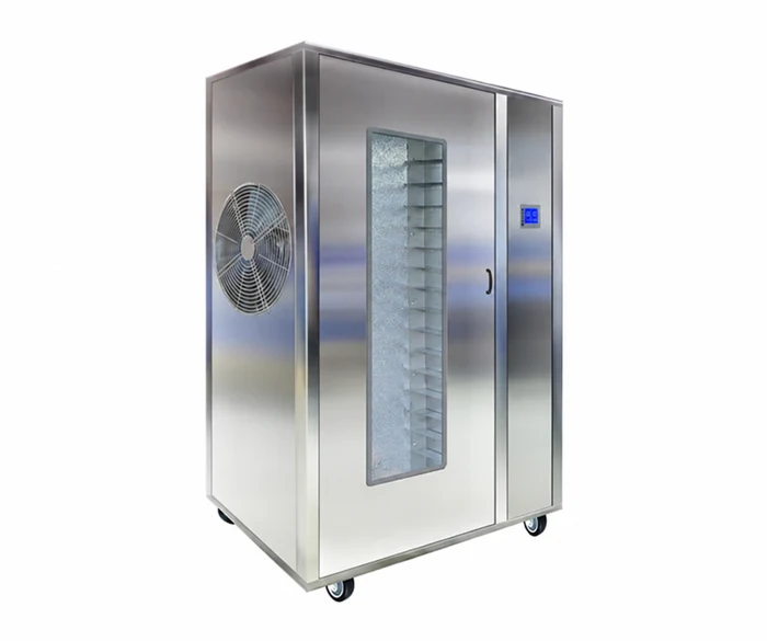 Stainless steel drying cabinet with trays visible through the door.
